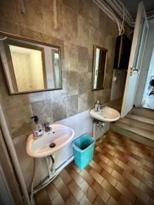a bathroom with two sinks and a tub at Panorama rooms in Chios