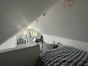 a bedroom with a bed with a black and white comforter at The Hideaway-Sharples-Bolton in Bolton