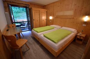 Letto o letti in una camera di Hotel Cime D'Oro