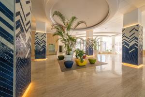 a hallway with potted plants in a building at Estival Park Almaris in La Pineda