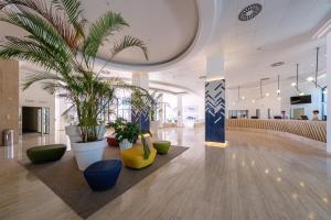 a lobby with potted plants in a building at Estival Park Almaris in La Pineda