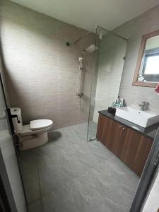 a bathroom with a shower and a sink and a toilet at Villa Đường Lâm- Sơn Tây in Hanoi