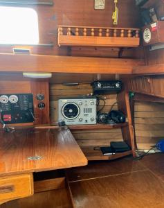 a room with a shelf with a radio on it at Pāvilostas_laivas in Pāvilosta