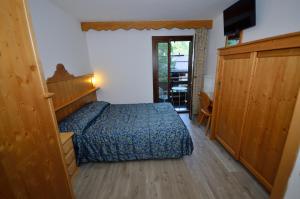 Letto o letti in una camera di Hotel Cime D'Oro