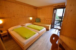 Letto o letti in una camera di Hotel Cime D'Oro