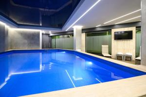 a large swimming pool in a hotel room at Hilltop North Avenue by Stellar Hotels, Yerevan in Yerevan