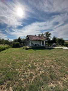 a house sitting on top of a grass field at Къща за гости Ива 