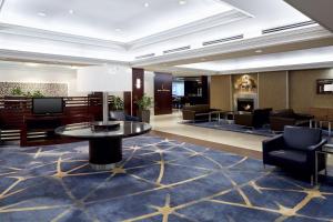 a lobby of a hotel with a table and chairs at Sheraton Montreal Airport Hotel in Dorval