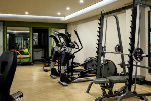 a gym with several tread machines in a room at Hilltop North Avenue by Stellar Hotels, Yerevan in Yerevan