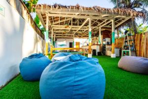 three large blue bean bags sitting on the grass at My Green Hostel in San Vicente