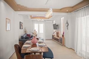 a living room with a wooden table and chairs at Rhodian Filoxenia in Rhodes Town