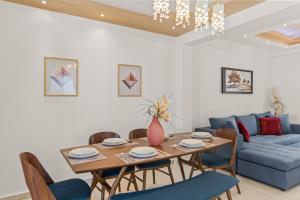 a dining room with a table and a blue couch at Rhodian Filoxenia in Rhodes Town +18 photos