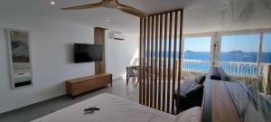 a living room with a view of the ocean at Principado Benidorm Suites Levante in Benidorm