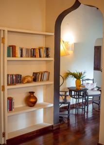 a living room with a book shelf filled with books at Saffron Garden Malindi in Malindi