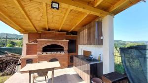 a outdoor kitchen with a pizza oven on a patio at Casa Mario in Isverna