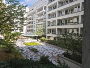 ein Apartmenthaus mit einem Gehweg davor in der Unterkunft TopDomizil Apartments Checkpoint Plaza in Berlin