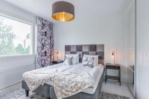 a bedroom with a large bed and a window at City Home Korkalonkatu in Rovaniemi