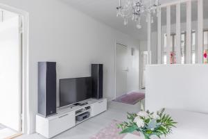 a living room with a flat screen tv on a cabinet at City Holiday Apartments 2 in Rovaniemi