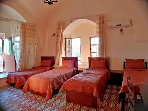 a bedroom with three beds in a room at Lamar Guesthouse - Hebron in Hebron