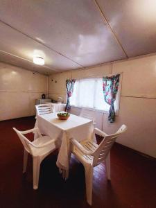 a dining room with a white table and chairs at Orelskyi Dvor in Mohyliv