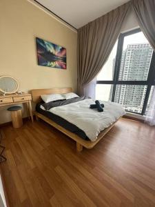 a bedroom with a bed and a large window at The Clio 2 IOI Resort City, beside ioi city mall, serdang hospital, upm and uniteen in Putrajaya