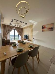 a dining room with a wooden table and chairs at The Clio 2 IOI Resort City, beside ioi city mall, serdang hospital, upm and uniteen in Putrajaya