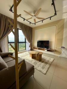 a living room with a couch and a ceiling fan at The Clio 2 IOI Resort City, beside ioi city mall, serdang hospital, upm and uniteen in Putrajaya