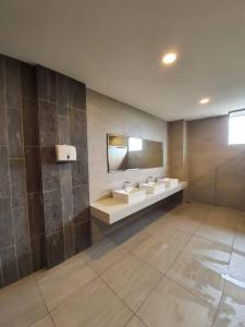 a bathroom with two sinks and a mirror at The Clio 2 IOI Resort City, beside ioi city mall, serdang hospital, upm and uniteen in Putrajaya