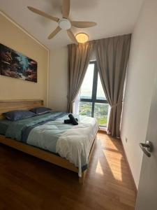 a bedroom with a bed and a ceiling fan at The Clio 2 IOI Resort City, beside ioi city mall, serdang hospital, upm and uniteen in Putrajaya