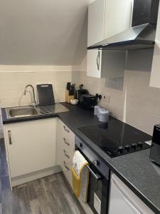 a kitchen with a sink and a stove top oven at 34D Genesta Road - Apartment with Balcony Sea Views with parking - Sleeps 4 in Westcliff-On-Sea