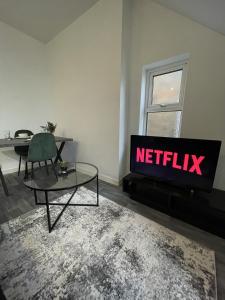 a living room with a tv with the netflix sign at Apartment with Balcony Sea Views with parking - Sleeps 4 in Westcliff-On-Sea