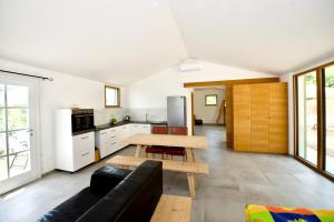 a kitchen with a couch and a table in a room at Poggio Ferrone in Suvereto