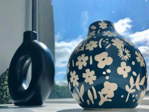 two vases sitting on a table next to a window at Home 2 Home Living in Clayton le Moors
