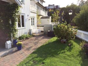 Un patio con una casa y algunas plantas. en Cosy flat for 4 persons, en Kristiansand