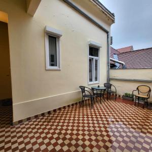 a patio with chairs and a table on a house at City Bell in Székesfehérvár