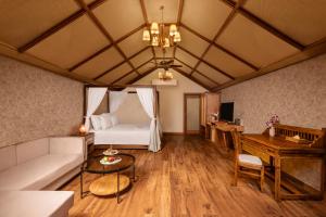 a living room with a bed and a table at Zana Forest Resort Ranthambore in Sawāi Mādhopur