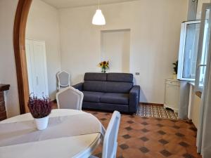 ein Wohnzimmer mit Sofa, Tisch und Stühlen in der Unterkunft Casa Macoca in Sperlonga