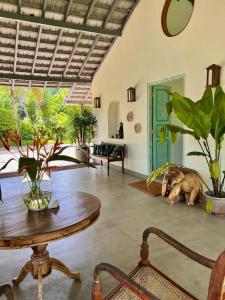 a living room with a table and some plants at The Jungle Loft Galle in Galle