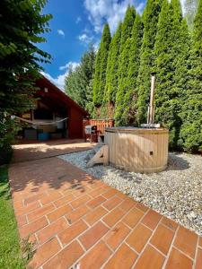 a garden with a brick patio and a hot tub at KAPINA sk - Holiday Homes in Žiar