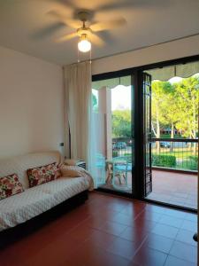 a living room with a couch and a balcony at bilocale in residence CIR 017067-LNI-00151 in Desenzano del Garda
