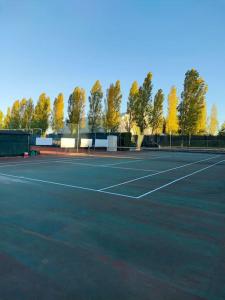 a tennis court with trees in the background at bilocale in residence CIR 017067-LNI-00151 in Desenzano del Garda