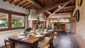 a dining room with a large wooden table and chairs at VILLA I LEVRIERI 8, Emma Villas in Tavarnelle Val di Pesa