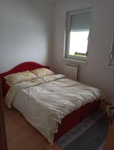 a bed in a bedroom with a window at Apartman MM , Banja Luka, Wi-Fi free,parking free in Banja Luka