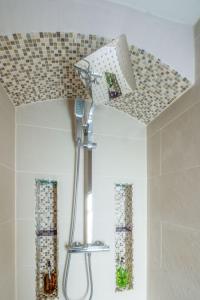 a shower in a bathroom with a ceiling at The Artist's Retreat in Brighton & Hove