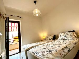 a bedroom with a bed and a window at Appartamento Panoramico su Lago in Trevignano Romano