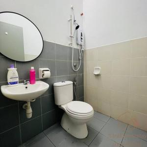 a bathroom with a shower and a toilet and a sink at Jalan Sena Indahpura Landed House in Kulai +9 photos