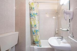a bathroom with a sink and a shower curtain at Santa Barbara by Umbral in Fátima +1 photo