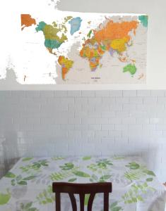 a map of the world hanging above a bed at Camera in stile Novecento in Florence