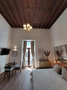 a bedroom with a bed and a table and a chandelier at Apartamentos La Florida in Arrecife