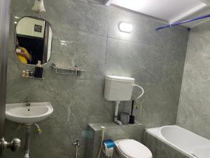 a bathroom with a sink and a toilet and a mirror at Sierra Vista Resort in Nashik +15 photos